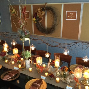 Autumn Thanksgiving table with hanging glass orb tall gold stands curly willow gold votives