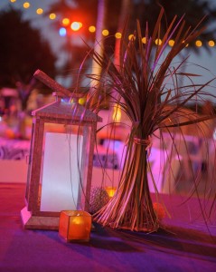 Galvanized Steel Hurricane Lanterns, Glowing Candles, Seashells and Cafe Lighting keep this event casual.