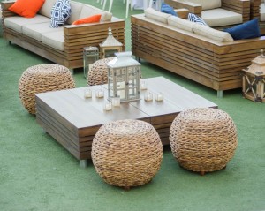 Low cocktail tables and abaca ottomans with collection of oversized lanterns